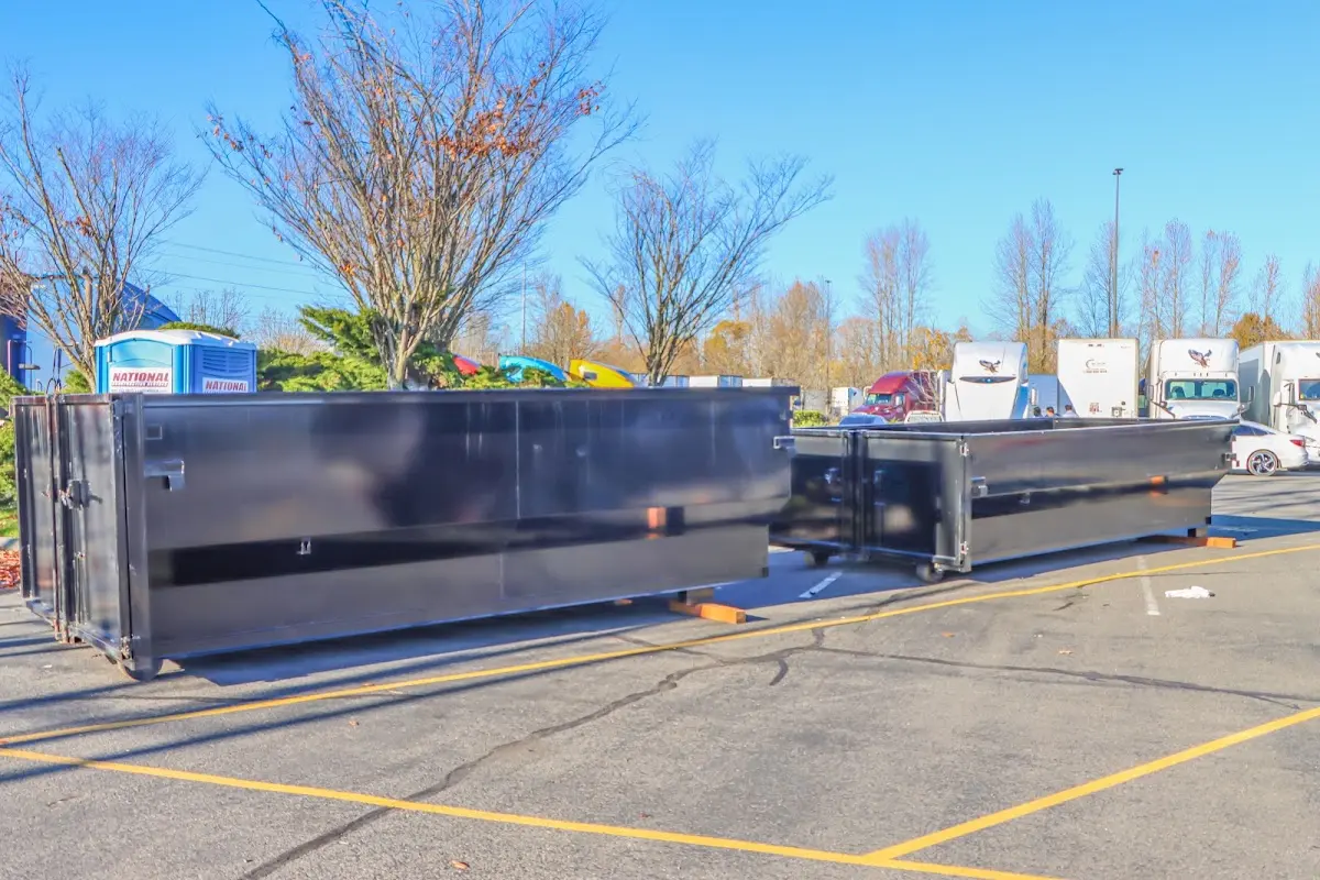 Professional dumpster rental service with roll-off container on residential driveway in Haddonfield